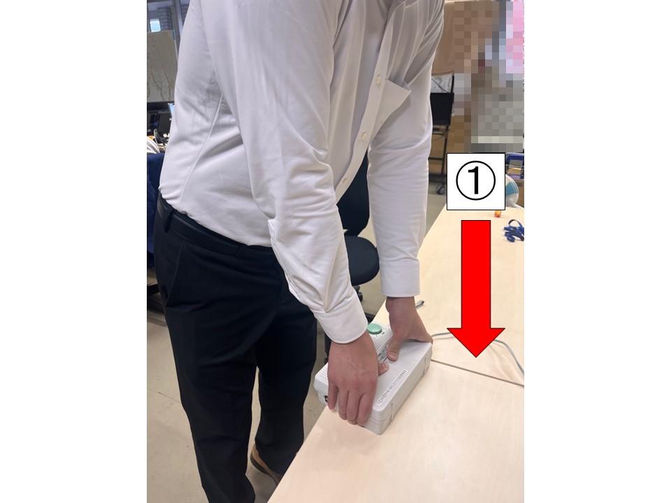個別受信機のフタを真上から強くおさえている写真