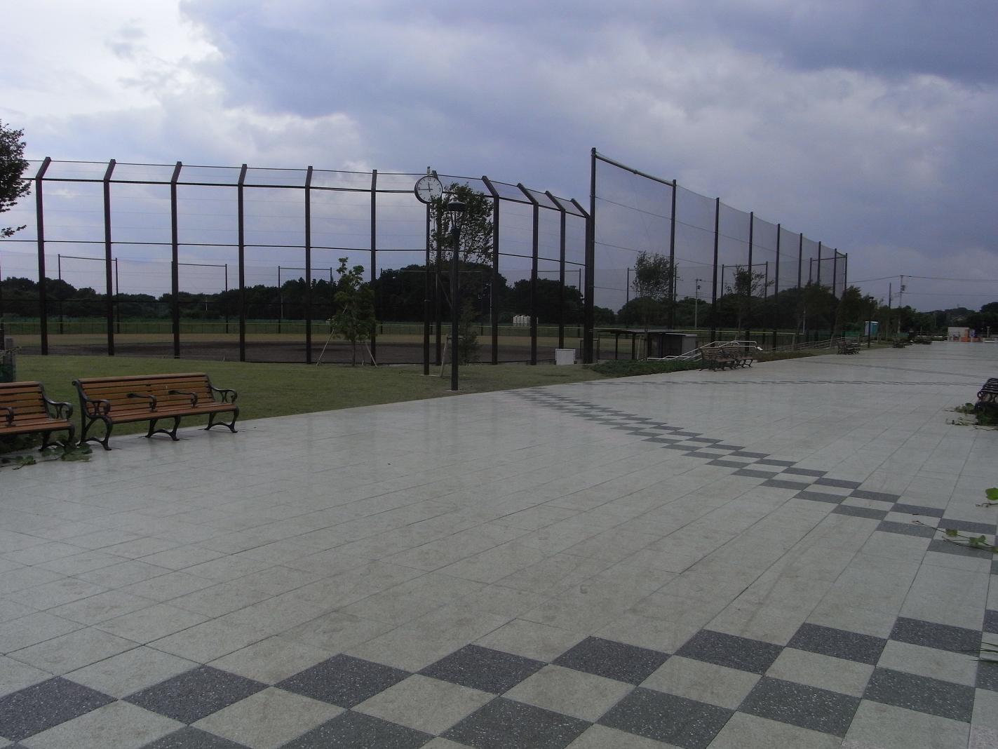 石畳の広い通路の奥に見える防球ネットで囲まれた第2野球場の写真
